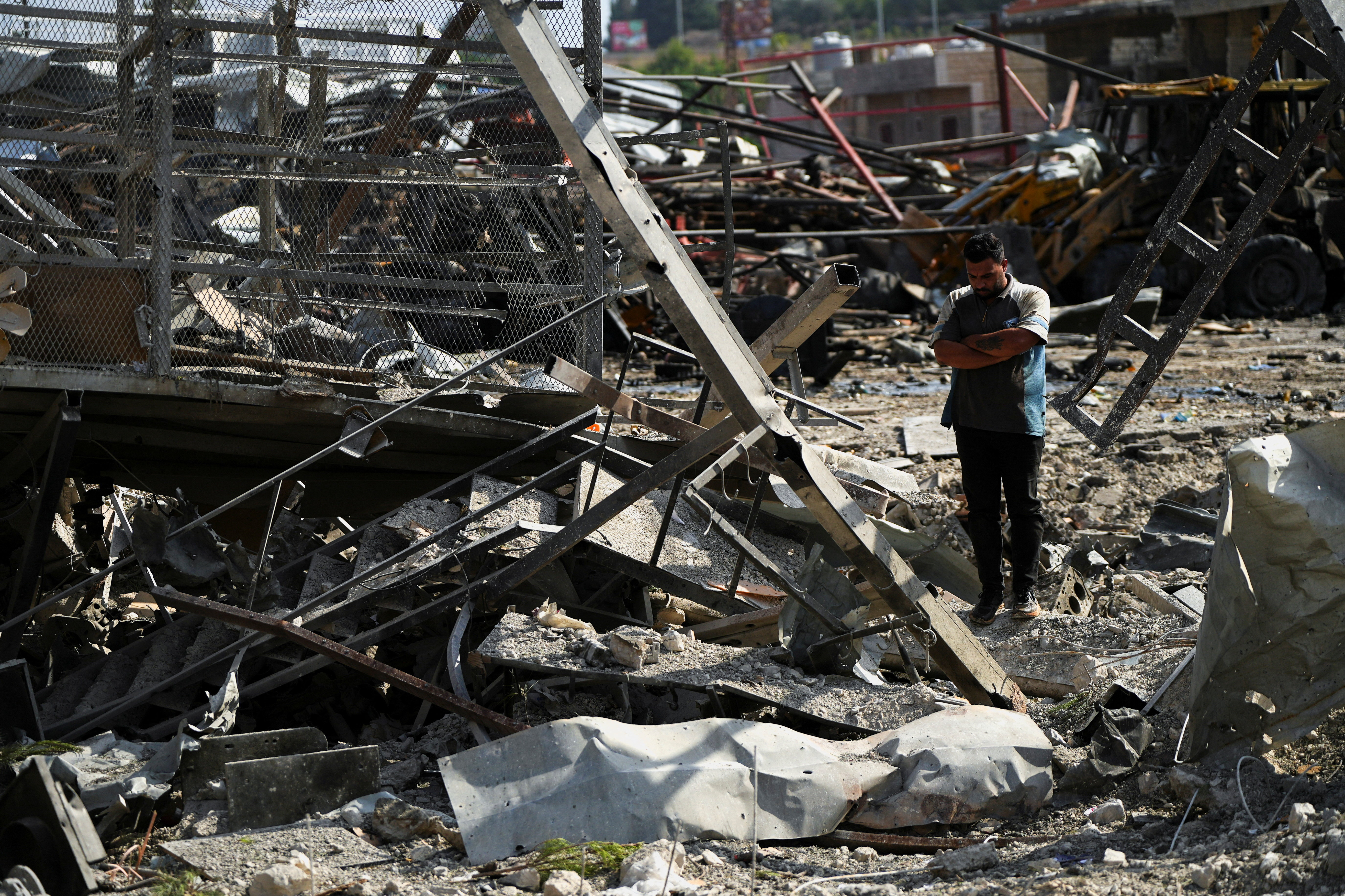 A man inspects a damaged site in the aftermath of Israeli strikes in Ansariyeh, south of Sidon, Lebanon. (Reuters)